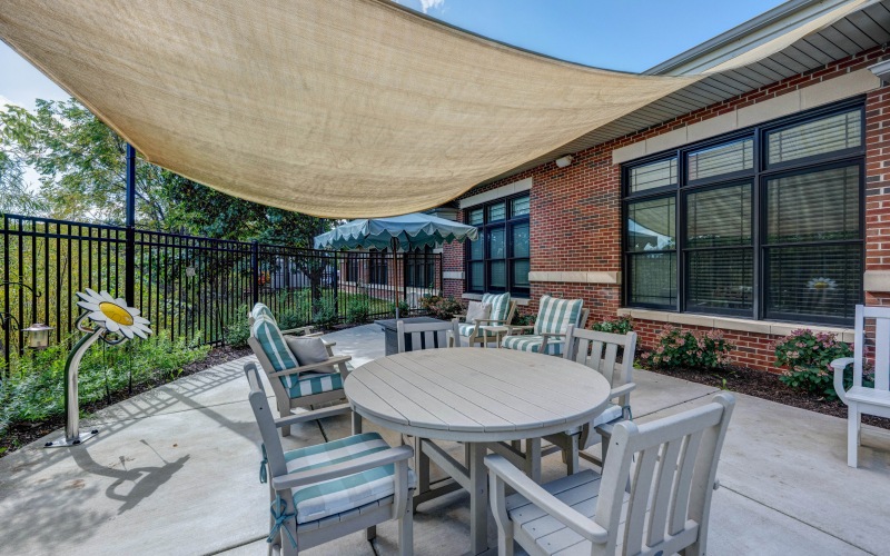 Outdoor covered patio with tables and chairs