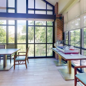 Find your perfect fit at The Auberge at Oak Village a room with tables and chairs
